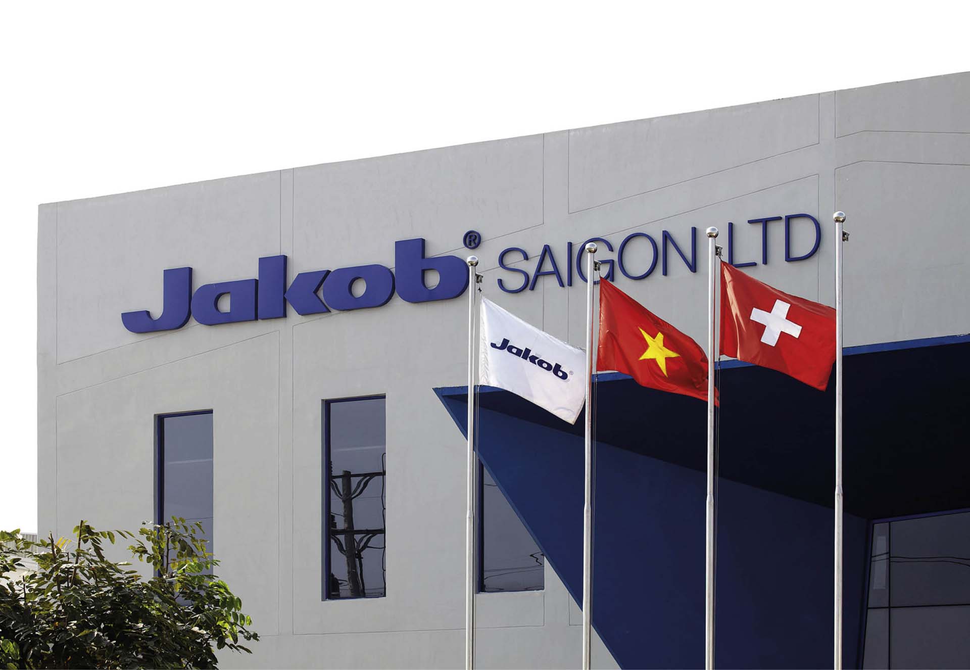 Image of Jakob Saigon factory in 2008 with the flags of Jakob, Vietnam and Switzerland